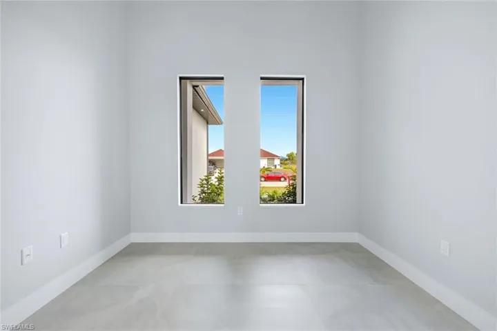 Empty room featuring baseboards