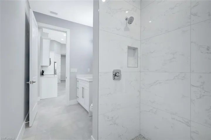 Bathroom with vanity and a tile shower