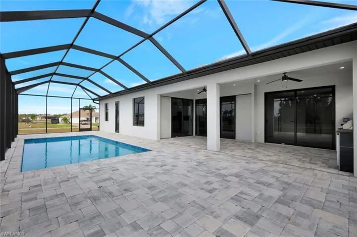Outdoor pool with a sunroom, a lanai, and a patio