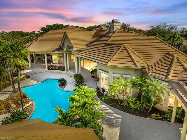 Pool at dusk with a patio area