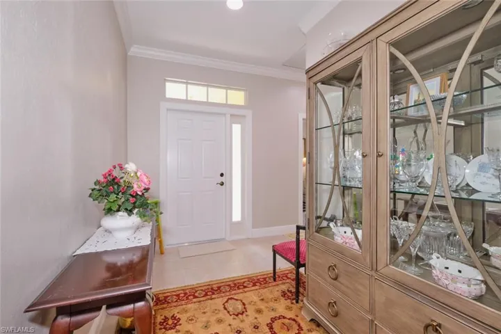 Tiled foyer entrance with ornamental molding