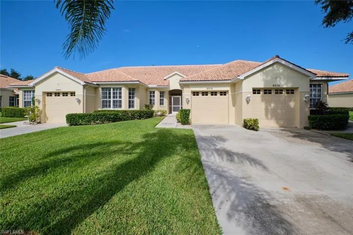 View of front facade with a front lawn and a garage
