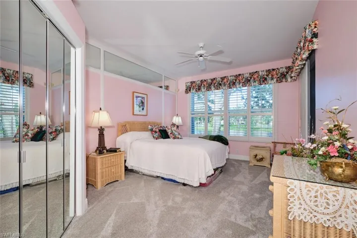 Carpeted bedroom featuring ceiling fan