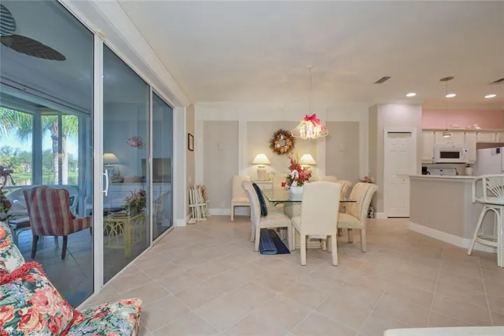 Tiled dining room featuring crown molding