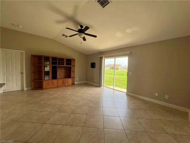 Large living/dining opens onto rear yard, kitchen, and pool area