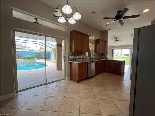 Kitchen has window over sink and nice sized breakfast nook that opens directly onto pool area.
