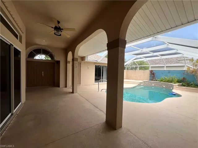 Double door entry opens to beautiful private pool area with water spickets and in-ground landscaping.