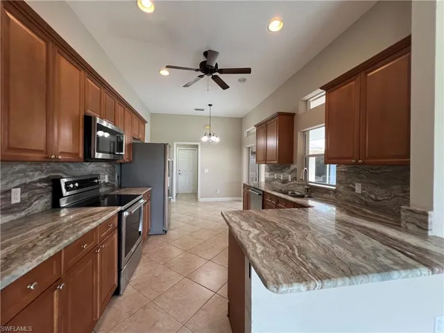 Beautiful kitchen with granite countertops and full stone backsplashes and Kitchen Aide stainless steel appliances.