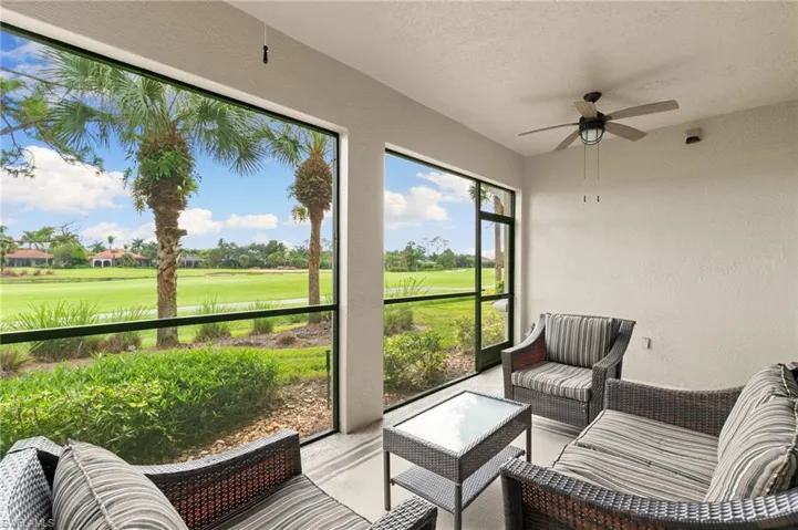 Sunroom / solarium with ceiling fan, view of golf course, and outdoor lounge area
