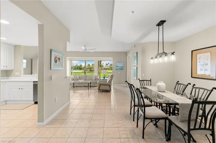 Dining room with light tile patterned flooring and ceiling fan