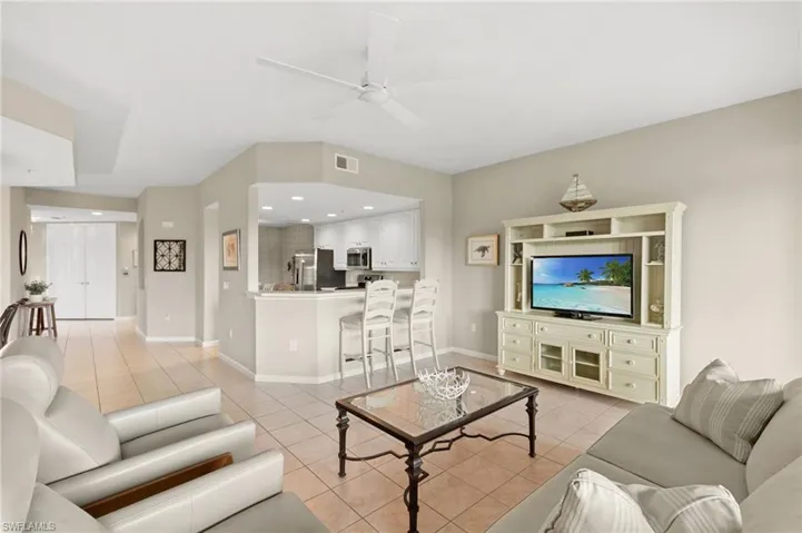 Living area featuring light tile patterned flooring, recessed lighting, and ceiling fan