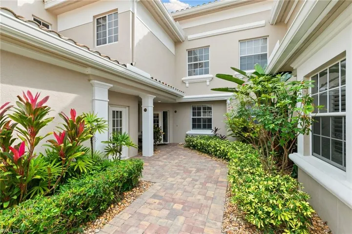 Doorway to property featuring stucco siding