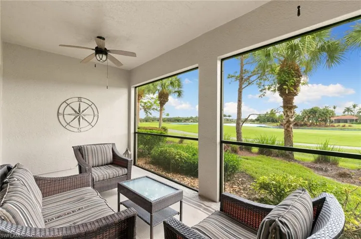 Sunroom / solarium with ceiling fan, view of golf course, a water view, and an outdoor hangout area