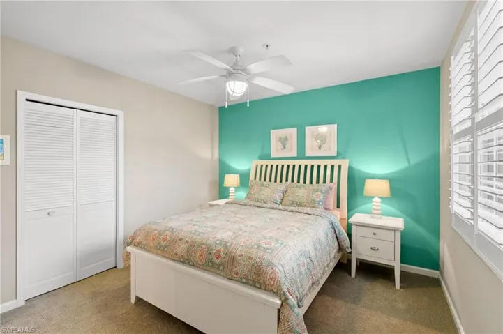 Bedroom with carpet floors, a closet, and a ceiling fan
