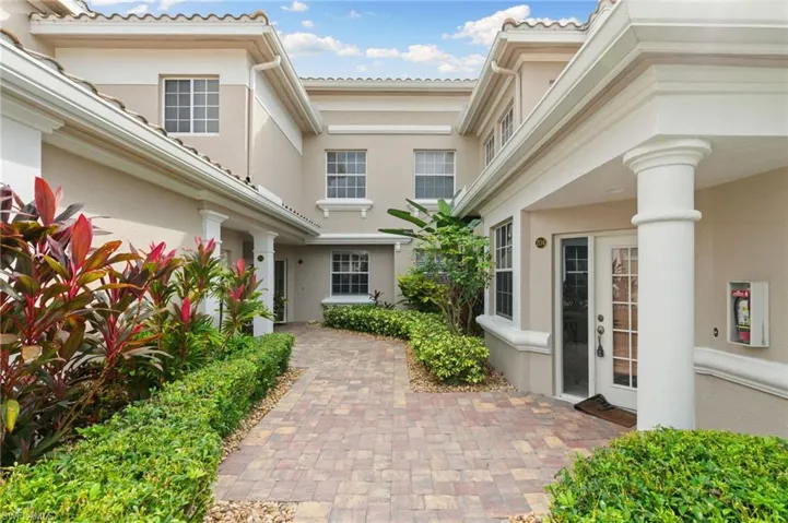Doorway to property featuring stucco siding