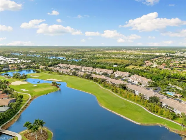 Aerial view of residential area with a large body of water and a golf course