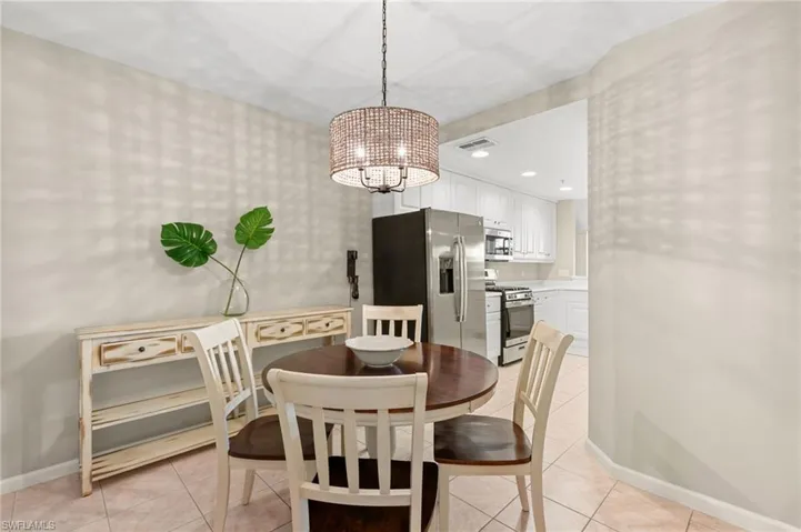 Dining area featuring a chandelier, light tile patterned floors, and recessed lighting