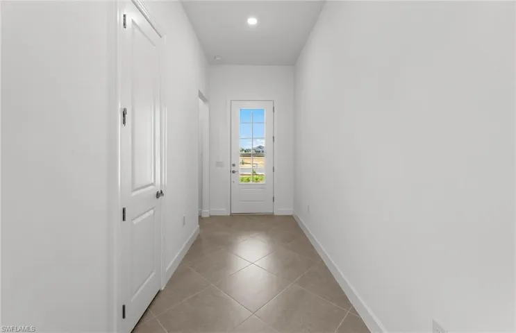 Hall with tile flooring