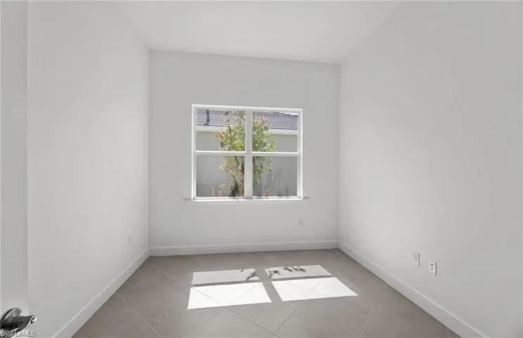 Empty room with light tile floors