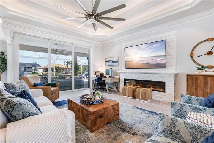 Living room with custom stone accent wall and electric fireplace