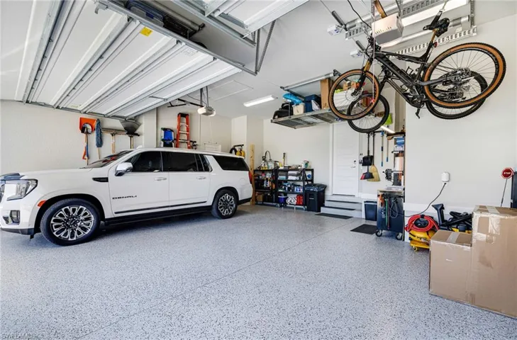Garage with epoxy coated floors, electric storage lifts