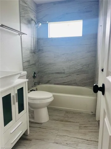 Bathroom with vanity and  shower combination