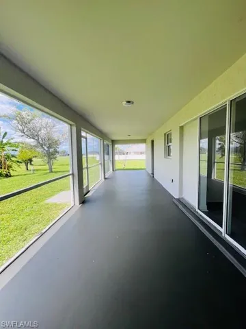 Unfurnished sunroom featuring finished concrete flooring