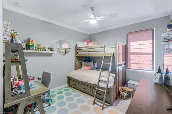 Bedroom featuring ceiling fan and crown molding