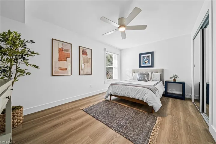 Guest Bedroom with light wood finished floors, a closet, and ceiling fan