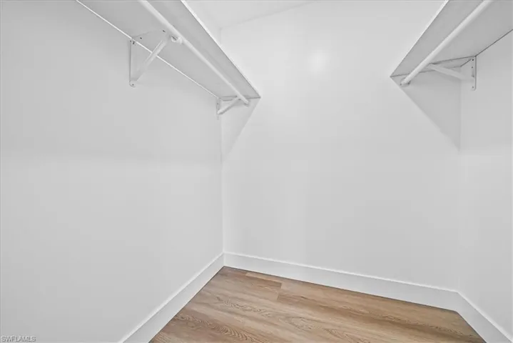 Walk in closet featuring wood finished floors