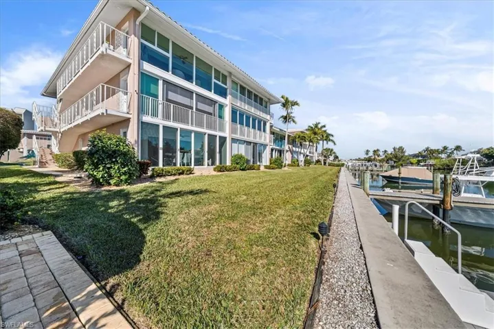 Dock area with a yard and a water view