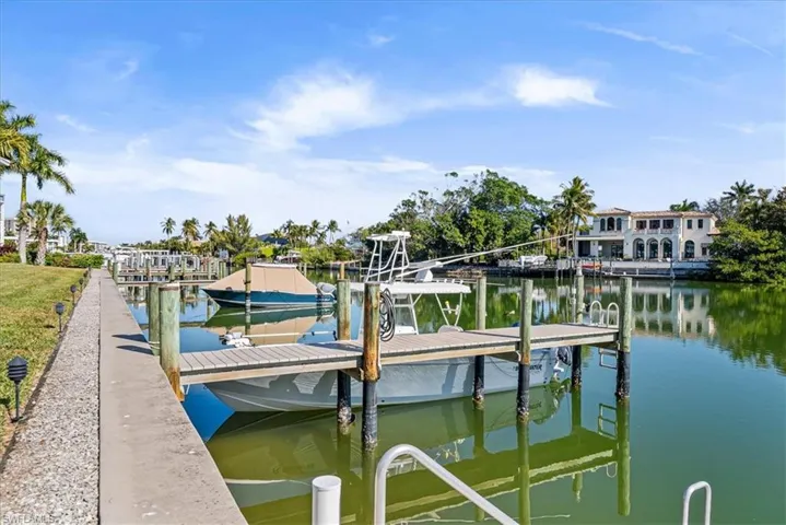 Dock area with a water view and boat lift
