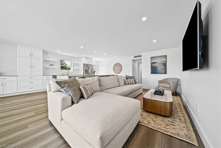 Living room with recessed lighting and light wood-type flooring