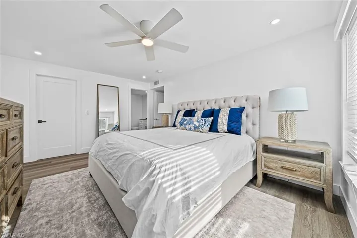Primary Bedroom featuring wood finished floors, a ceiling fan, and recessed lighting