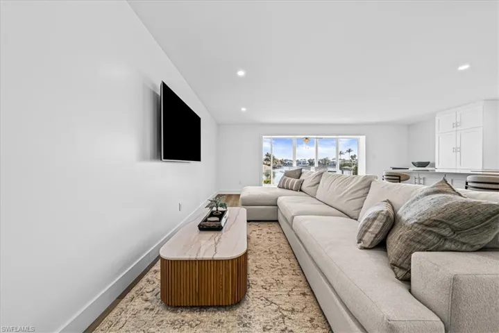 Living room featuring baseboards and recessed lighting
