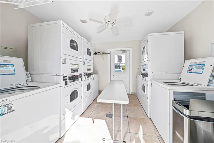 Shared laundry room featuring stacked washing machine and dryer, ceiling fan, and separate washer and dryer