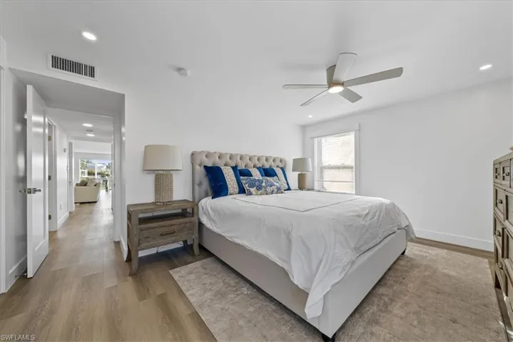 Bedroom with multiple windows, wood finished floors, ceiling fan, and recessed lighting