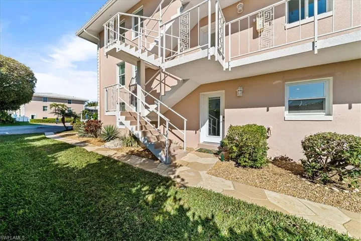 View of property featuring stairs
