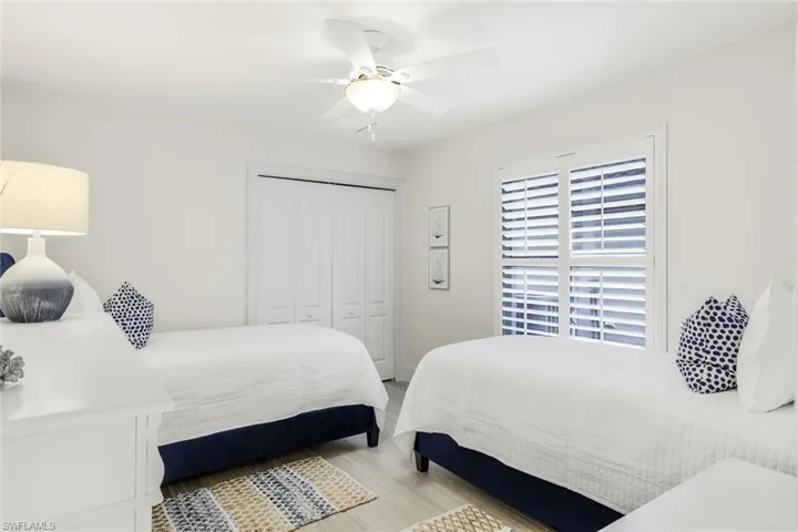 Bedroom featuring ceiling fan, a closet, and hardwood / wood-style flooring