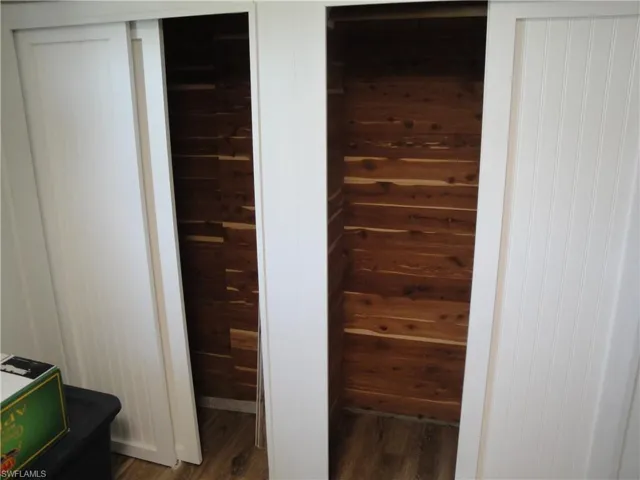 Cedar lined closet with sliding white shaker panels.