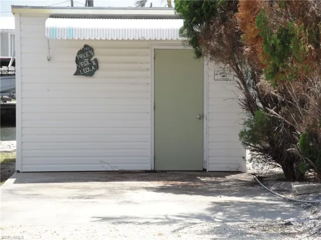 Large garage/storage/workshop with overhead lighting and electrical outlets.