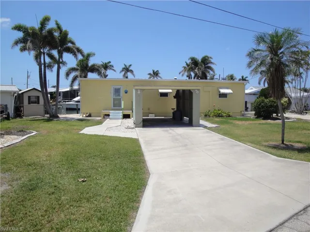 Long driveway with detached carport