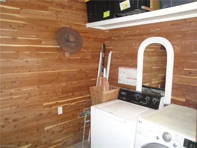 Laundry room just off the master bedroom. Completely cedar lined walls, 2 sets of storage shelving, washer and dryer.