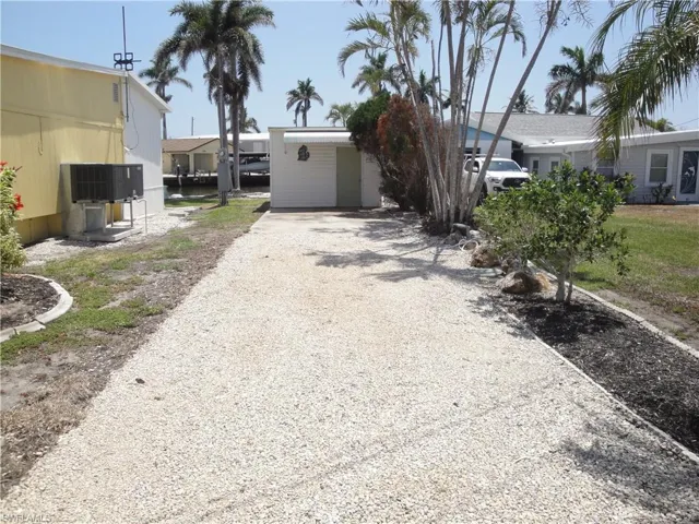 Second driveway with room for an RV, boat trailer, and more. Detached garage.
