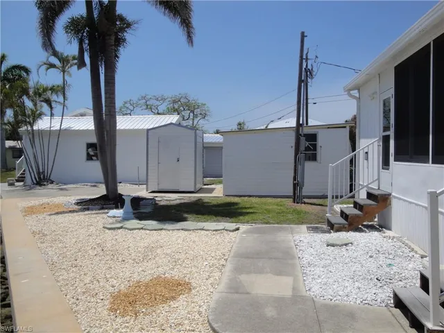 Small storage shed for bicycles and boating equipment. side view of the larger garage.