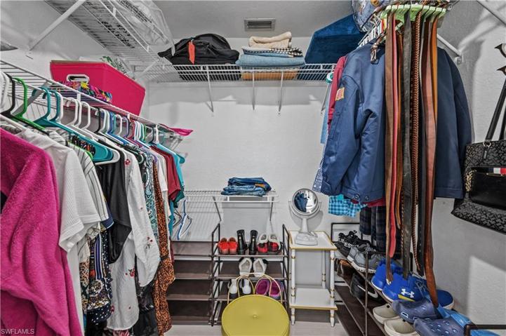 Walk in closet in primary bedroom