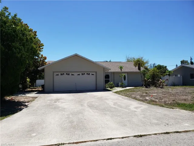 Single story home featuring driveway and a garage