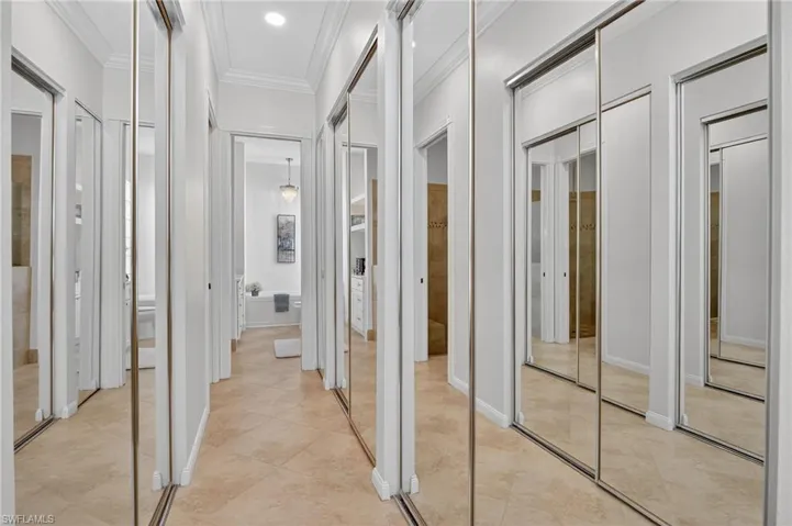Hallway to ensuite bathroom with mirrored closet doors