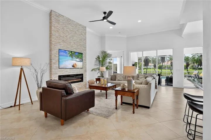 Great room, with stone wall, fireplace and lots of natural light