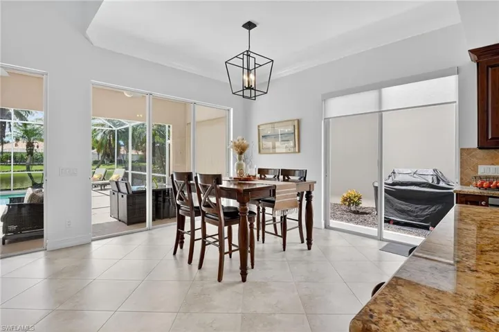 Dining space with crown molding, light tile patterned floors, and a chandelier
